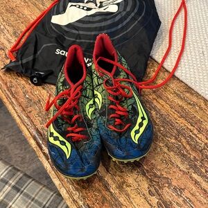 Saucony Red and Blue athletic shoes with spikes